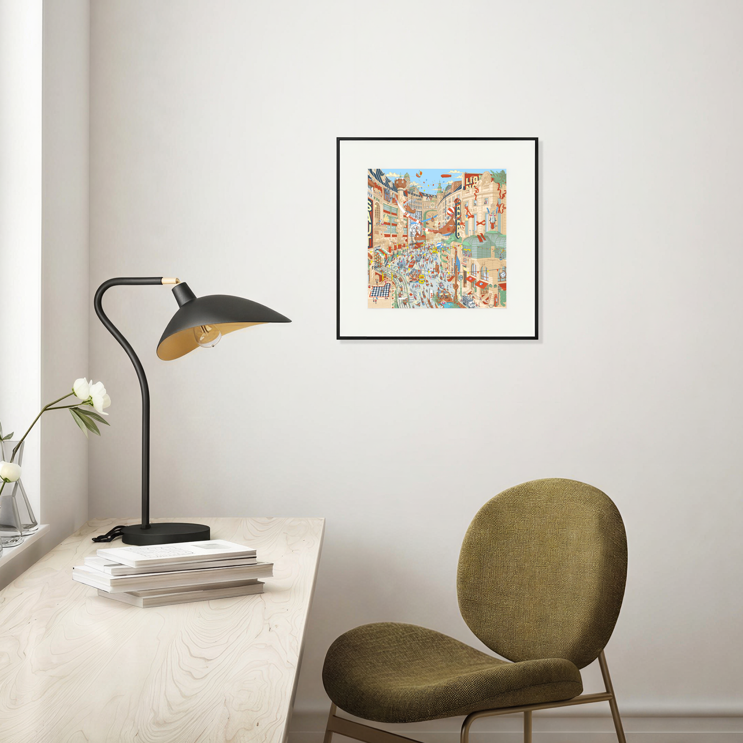 Framed artwork above a desk with a lamp and chair in a room.