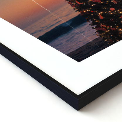 Framed artwork with a sunset over water and tree reflection