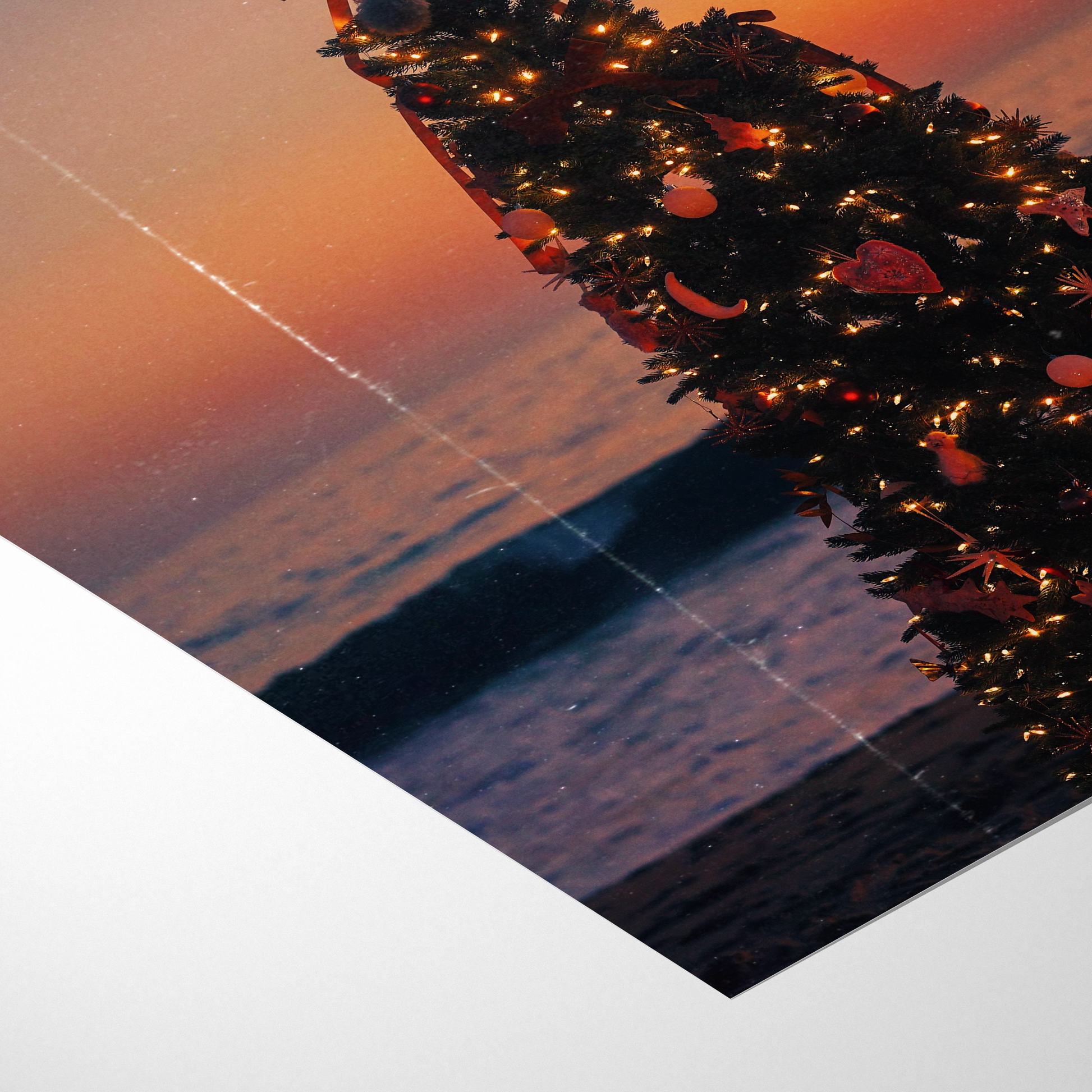 Decorative wreath with lights on a reflective surface at sunset