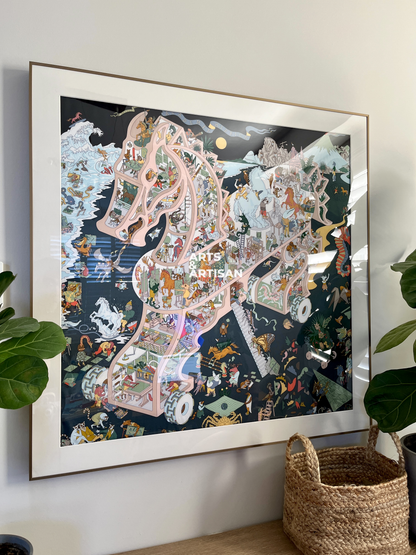 Framed artwork of a scarf frame, Hermes scarf frame on a wall with plants and a basket below.