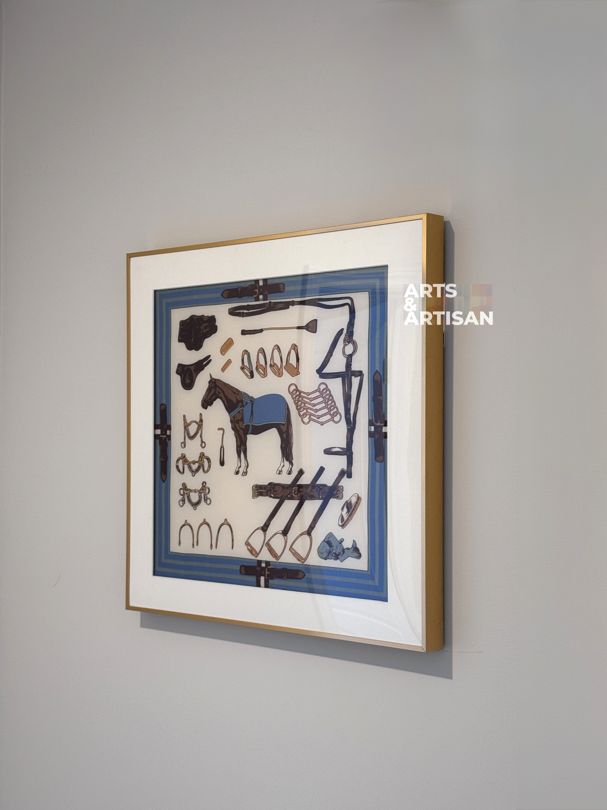 Framed scarf frame, Hermes scarf frame, with a blue background and various objects, displayed on a gray wall.
