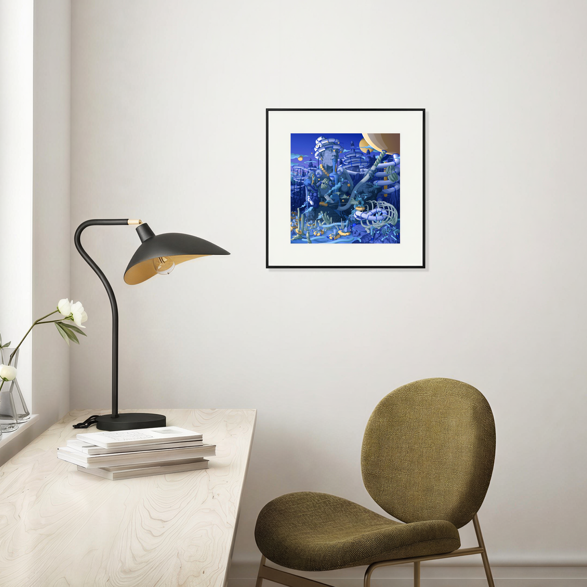 Framed artwork above a desk with a lamp and chair in a room setting