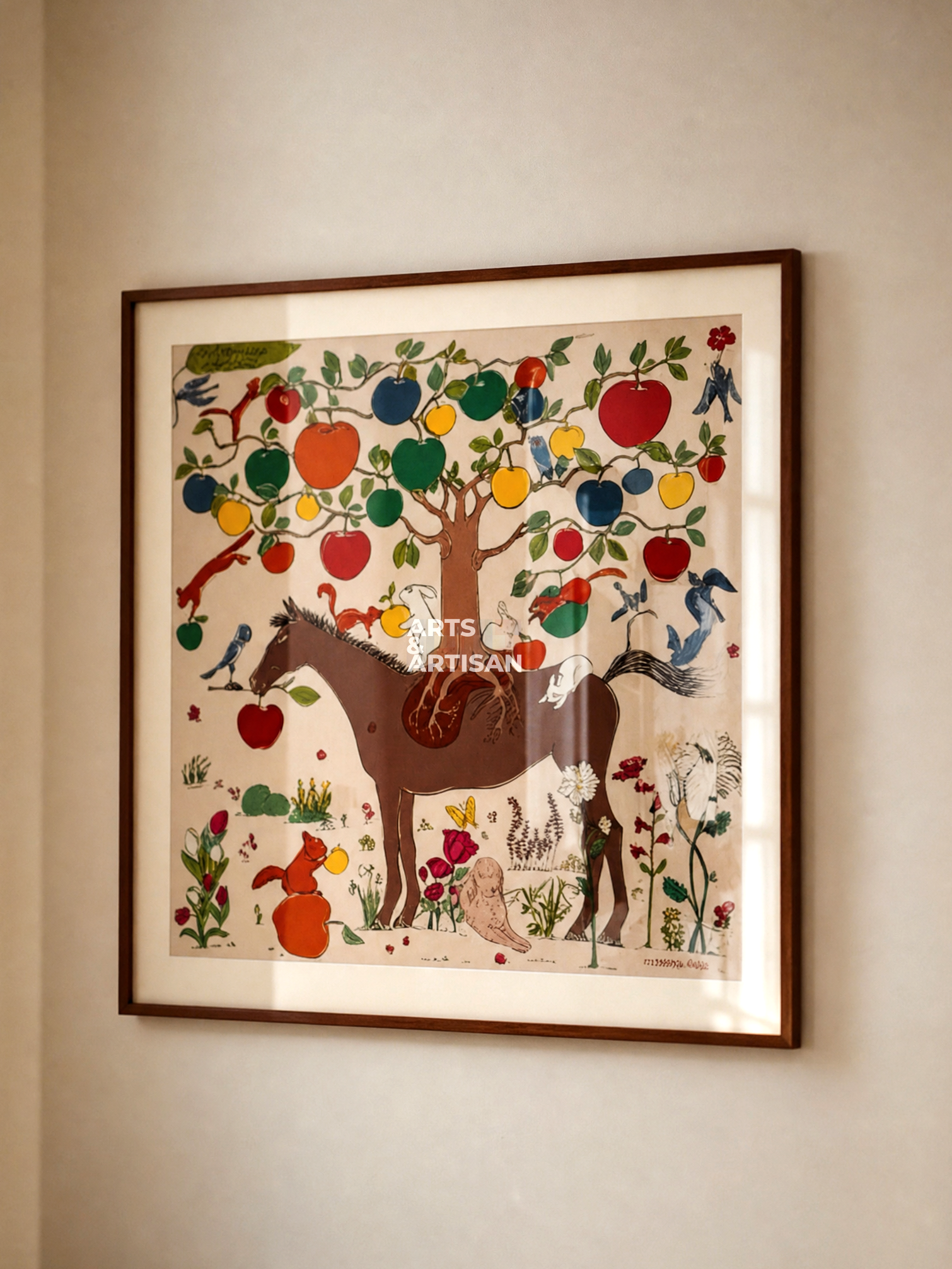 A framed folk art print depicting a horse under a tree of colorful apples, hung on a beige wall.