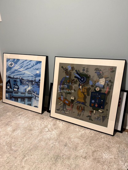 Two Hermes scarves 70 leaning against a light gray wall on a textured beige carpet. The left print shows a blue-toned architectural or landscape scene, and the right print is a collage-style artwork with the words 'ARTS ARTISAN' 