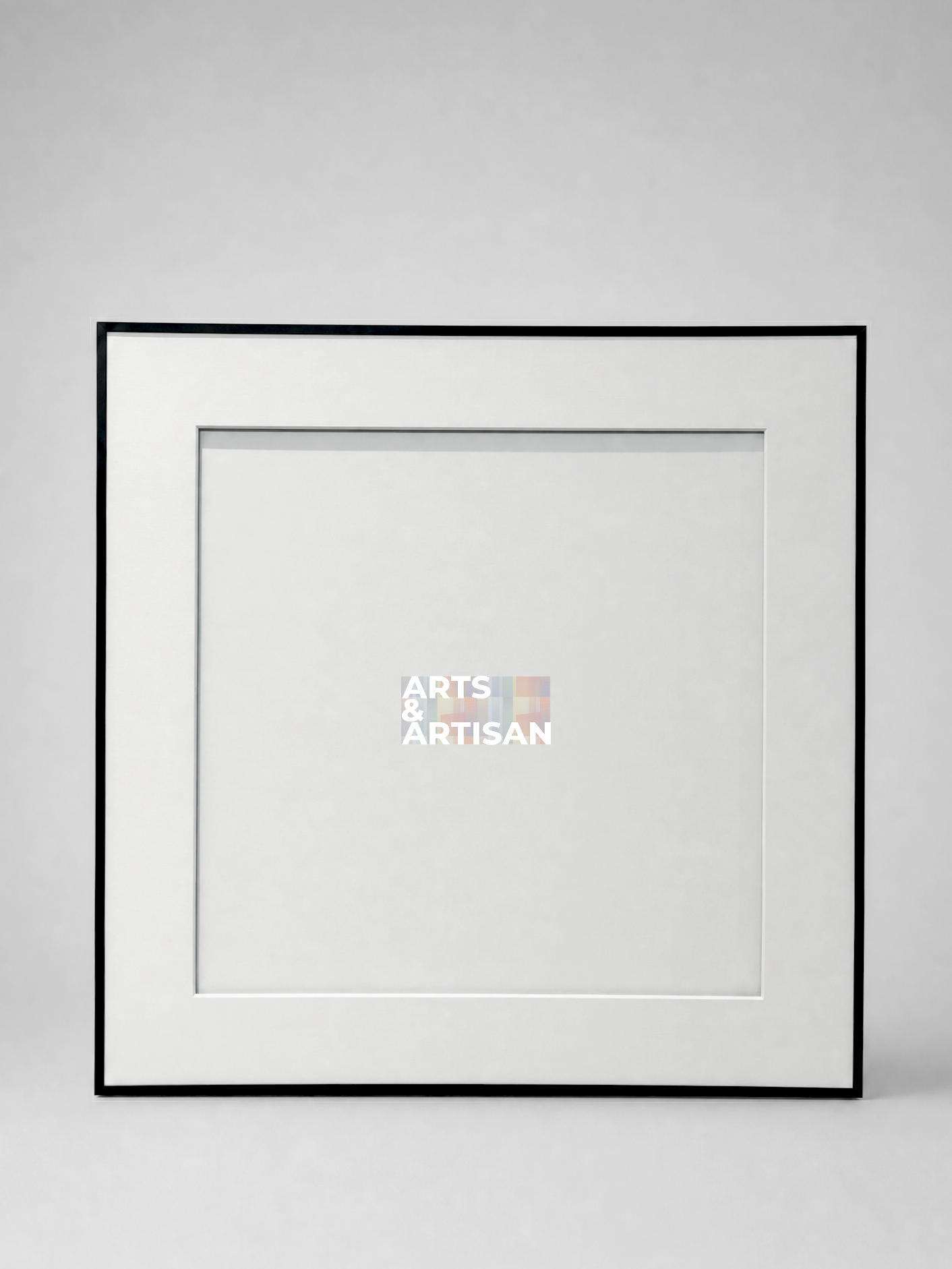 A square picture frame with a thin black border and a wide white mat, shown against a light gray background. A small Arts & Artisan logo is visible in the center of the mat.