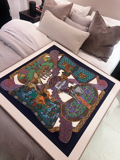 Copper Bronze Hermès scarf frame by Arts & Artisan with a framed silk scarf on a bed